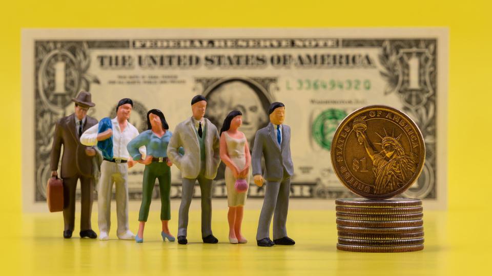 toy people standing in line in front of a stack of coins