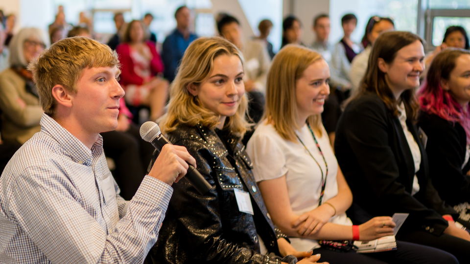 Man in audience holding microphone
