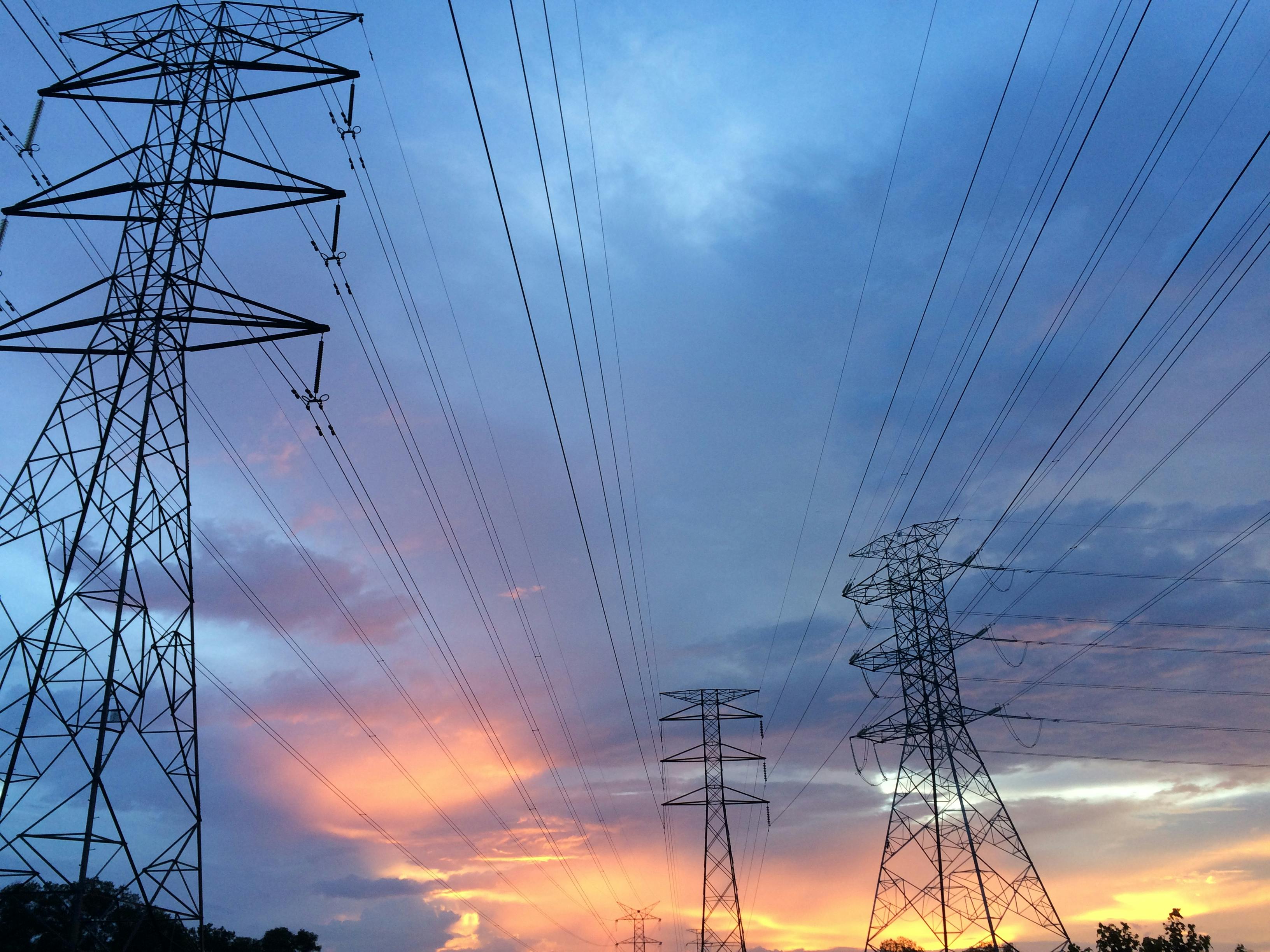 power transmission towers at sunset