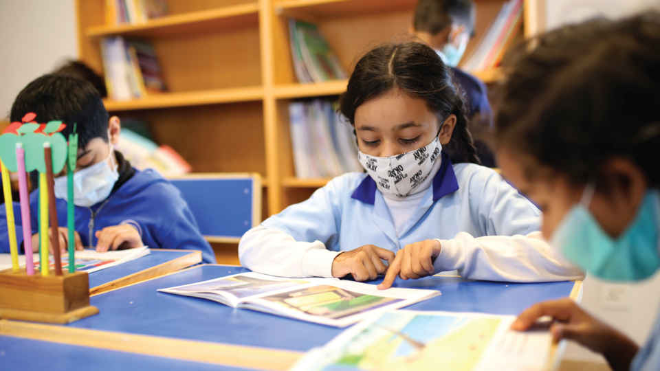 Students reading with masks on
