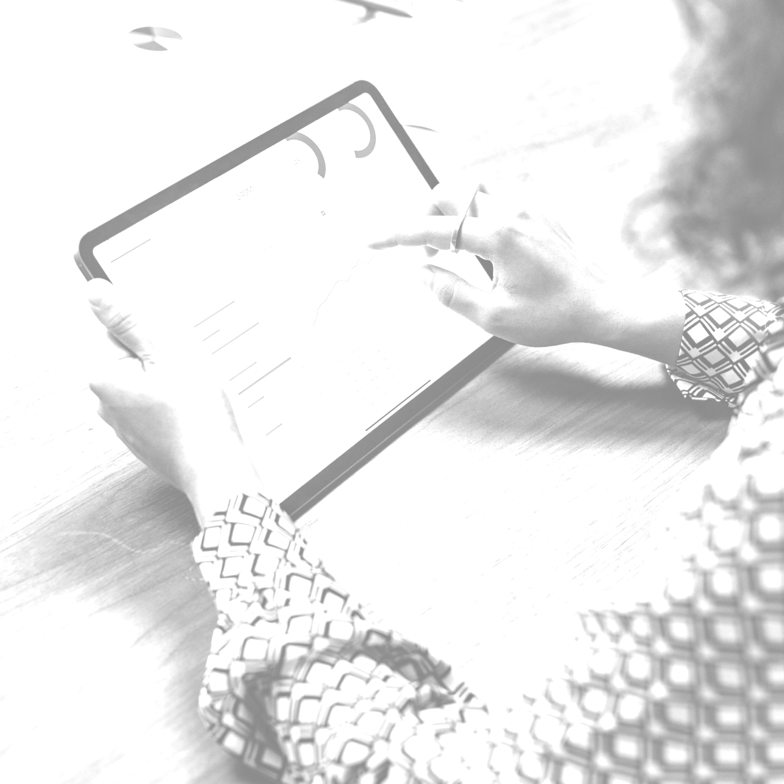 Woman using a tablet with graphs on it. 